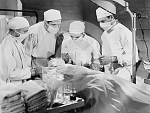 Group of doctors performing surgery