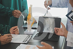 Group of doctors reading a document in meeting room at hospital