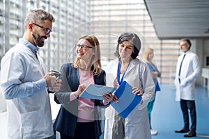 Group of doctors talking to pharmaceutical sales representative.