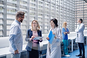 Group of doctors talking to pharmaceutical sales representative.