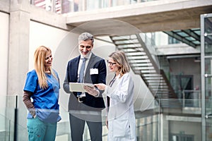 Group of doctors talking to pharmaceutical sales representative.