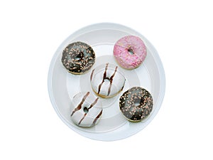 A group of doughnut items on a light plate. Isolated on a white background, top view