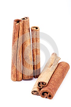 Group of dried cinnamon stics isolated on white background