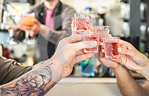 Group of drunk friends toasting cocktails at bar restautant