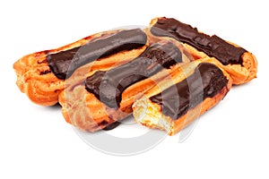 Group of eclairs with custard and chocolate icing isolated on white background. Sweet pastry products