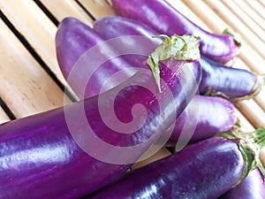 Group of Eggplants on Bamboo Surface