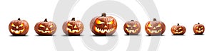 A group of eight lit spooky halloween pumpkins, Jack O Lantern with evil face