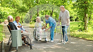 Group of elderly patients with nurse. Assisting seniors