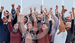 a group of elderly people raised their hands up