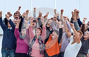 a group of elderly people raised their hands up