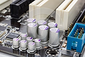 Group of electrolytic capacitors closeup on motherboard