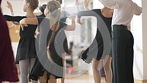 Group of elegant Caucasian children rehearsing waltz in fourth position in dancing school. Confident skilled boys and