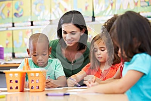 Group Of Elementary Age Children In Art Class With Teacher