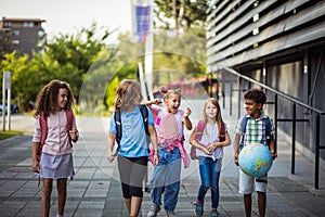 Group of elementary age schoolchildren outside. Happy days of childhood