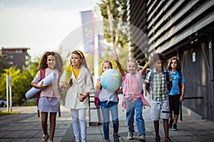 Group of elementary age schoolchildren outside. Happy school kids