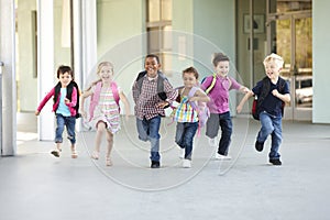 Group Of Elementary Age Schoolchildren Running Outside