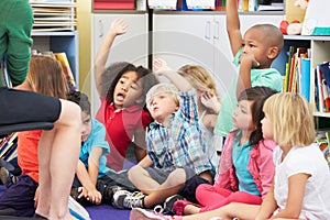 Group of Elementary Pupils In Classroom Answering Question