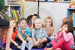 Group of Elementary Pupils In Classroom Touching Noses