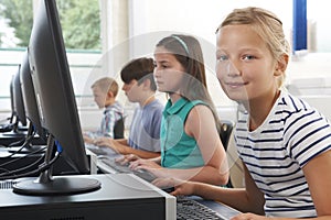 Group Of Elementary School Children In Computer Class