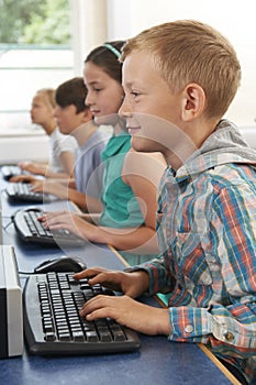 Group Of Elementary School Children In Computer Class