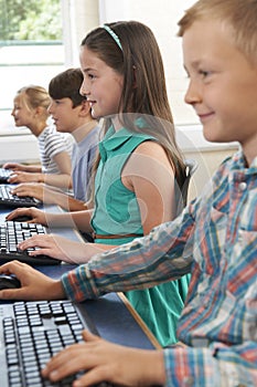 Group Of Elementary School Children In Computer Class