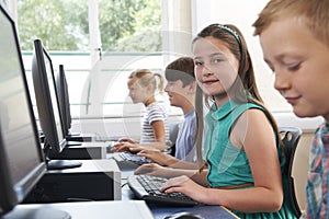 Group Of Elementary School Children In Computer Class