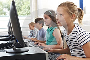 Group Of Elementary School Children In Computer Class