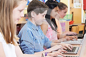 Group Of Elementary School Children In Computer Class