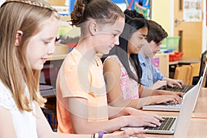 Group Of Elementary School Children In Computer Class