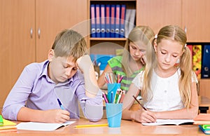 Group of elementary school pupils takes the test in class
