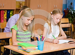 Group of elementary school pupils takes the test in class