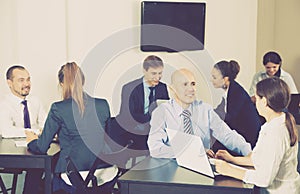 Group of employees with laptops in office