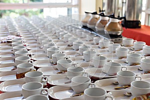 Group of empty ceramic cup and saucer serving tea or coffee in Hotel setting