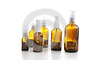 Group of empty glass spray bottles over white background