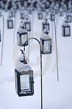 Group of empty lanterns in a cemetery in winter
