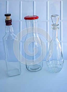 A group of empty wine bottles with a lid and cork. Glass eco-friendly containers. zero waste