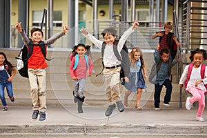 A group of energetic elementary school kids leaving school