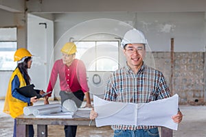 Group of engineer checking the blueprint on the table and talking about construction project with commitment to success at