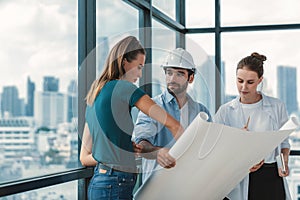 Group of engineer looking at project plan while brainstorming idea. Tracery.