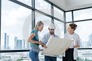 Group of engineer looking at project plan while brainstorming idea. Tracery.