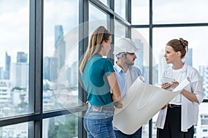 Group of engineer looking at project plan while brainstorming idea. Tracery.