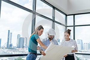 Group of engineer looking at project plan while brainstorming idea. Tracery.