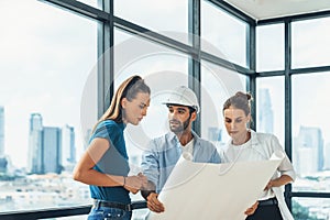 Group of engineer looking at project plan while brainstorming idea. Tracery.