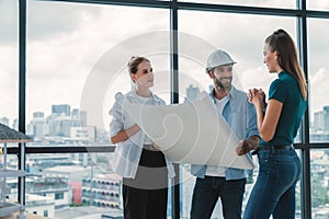 Group of engineer looking at project plan while brainstorming idea. Tracery.