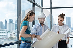 Group of engineer looking at project plan while brainstorming idea. Tracery.