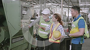 Group of engineer talking and training working using machine control together in industrial factory.