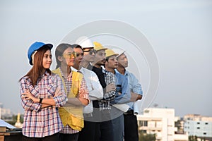 Group of engineers and architects standing and looking at site