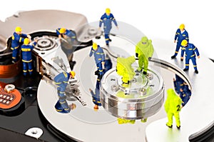 Group of engineers maintaining hard drive
