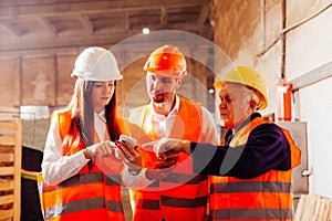 Group of engineers and workers discuss production plans