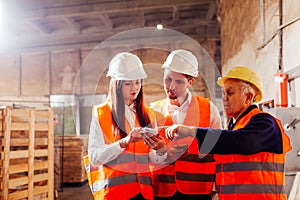 Group of engineers and workers discuss production plans